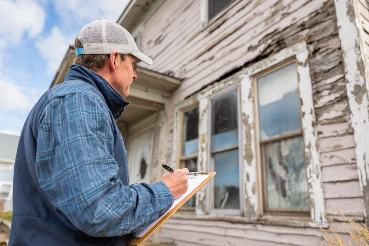 Property inspector assessing storm damage to Virginia home exterior